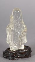 A CHINESE ROCK CRYSTAL FIGURE OF LOHAN, 10.5cm high with hardwood stand