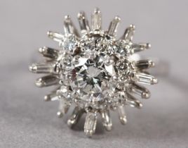 A DIAMOND CLUSTER RING, the principal brilliant cut stone claw set and raised against undulating