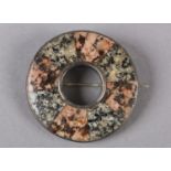 A VICTORIAN SCOTTISH PEBBLE SILVER SHIELD BROOCH, the segmented pink and grey granites collet set to