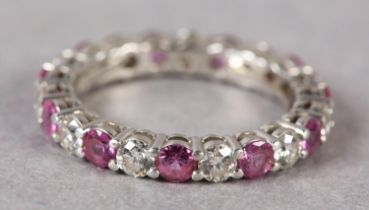 A RUBY AND DIAMOND ETERNITY RING BY TIFFANY AND CO in platinum, the circular faceted rubies and