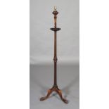 AN EARLY 20th CENTURY MAHOGANY STANDARD LAMP on a fluted and reeded column with lobed collar, on