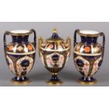 A PAIR OF ROYAL CROWN DERBY IMARI PATTERN urn vases with date cyphers for 1925 together with a