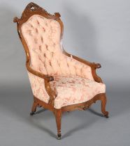 A LATE 19TH CENTURY ROSEWOOD ARMCHAIR, having foliate carved and pierced cresting, the waisted