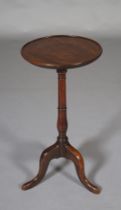 A GEORGE III MAHOGANY TRIPOD TABLE having a circular dished top on a slender ring turned column