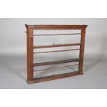 A GEORGE III OAK DELFT RACK OF SMALL PROPORTIONS, having an moulded dentil cornice with bracketed