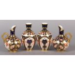 A PAIR OF ROYAL CROWN DERBY IMARI PATTERN EWERS with moulded gilt handles together with a pair of