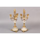 PAIR OF GILT AND ALABASTER FOUR LIGHT CANDELABRAS, foliage sconces supported by scrolled arms with