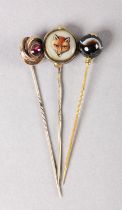 A VICTORIAN REVERSE PAINTED FOX MASK STICK PIN IN ROLLED GOLD together with Victorian agate ball