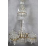 A SIX TIER CHANDELIER ON A GILT METAL FRAME, hung with prismatic drops, the top two tiers each