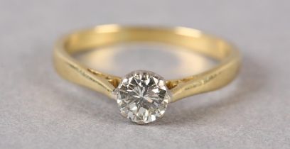 A SINGLE STONE DIAMOND RING, the brilliant cut stone crown set in yellow and white metal (tests as