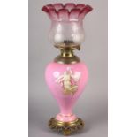 A VICTORIAN PINK PORCELAIN AND BRASS OIL LAMP BY WRIGHT & BUTLER, the inverted baluster body printed