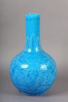 A CHINESE TURQUOISE GLAZED VASE, the elongated neck incised with a band of stiff leaves above a