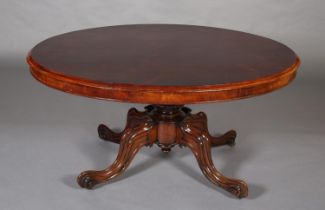 A VICTORIAN LOOE TABLE, having an oval tilt top, on short lobed column and quadruple base with