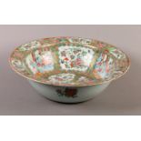 A CHINESE FAMILLE ROSE PUNCH BOWL, 19th century, painted with figures on a terrace and with peony,