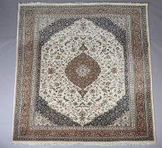 A MIDDLE EASTERN CARPET, the deep blue field having an ivory panel filled with scrolling leafage and