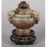 A CHINESE CARVED HARDSTONE INCENSE BURNER AND COVER OF GREEN-BROWN COLOUR, having a domed and