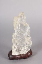 A CHINESE ROCK CRYSTAL FIGURE OF THE IMMORTAL MAGU, holding a fruiting branch, a deer at her feet,