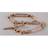 A GEORGE V BRACELET IN 9CT ROSE GOLD FETTER AND TRACE LINKS with T bar and swivel fastener,