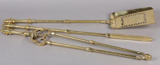 A MID 19TH CENTURY SET OF THREE BRASS FIRE IRONS having baluster turned handles and knop finials