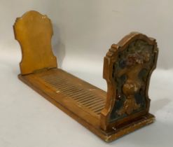 A gilt and polychrome gesso folding book stand, the end panels carved in relief with flower-filled