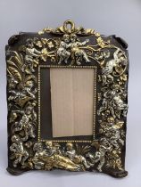 Art Nouveau style continental copper picture frame moulded with cherubs and scrolling vine with loop