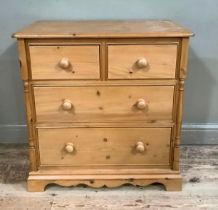 A pine chest of two short and two long graduated drawers, turned handles and half turned pilasters