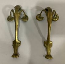 A pair of Art Nouveau gilt brass furniture mounts cast as scrolling plant forms on a paw foot, 16.