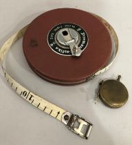 A brass tape measure by The Taylor Rolph Co Ltd, Mortlake London together with a Freemans Plastika