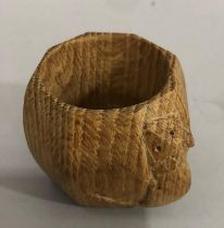 A Thompson of Kilburn 'Mouseman' oak napkin ring carved in high relief with a mouse, 5cm high