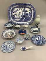 A large 19th century blue and white willow pattern meat dish, together with further 19th century and