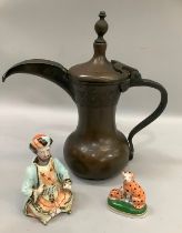 A German bisque figure of a Middle Eastern man with nodding head, a bronze dallah coffee pot and
