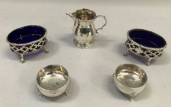 A pair of silver open salts, oval, pierced with blue glass liners on claw and ball feet, London