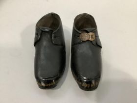 A pair of early 20th century children's clogs with a buckle, marked 1900 to base