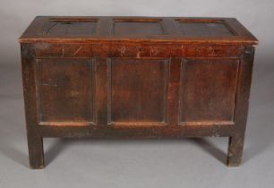 An Early 18th century oak kist having a triple indented top above a frieze carved with the