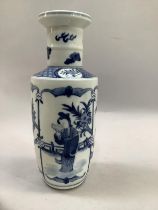 A Chinese blue and white Kangxi style rouleau vase painted with a figure reading in a garden