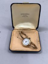 A George V ladies wrist watch in 9ct gold case on a later expanding 9ct gold bracelet