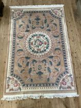 Two large washed wool Chinese carpets with raised flowers on peach ground with fringing, 193cm x