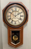A walnut and ebonised wall clock by the Ansonia clock company, New York, having a cream dial with