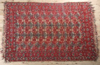 A Middle Eastern rug, the flatweave field of camel colour with thin red stripe, filled with ten rows