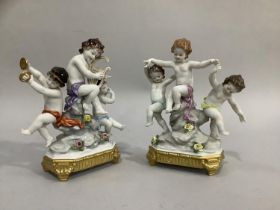 A continental porcelain figure group of three cherubs playing musical instruments on a