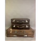 Thee vintage brown leather suitcases, leather handles, white metal hardwear, bearing traces of old