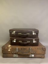 Thee vintage brown leather suitcases, leather handles, white metal hardwear, bearing traces of old