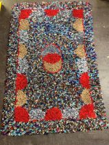 A colourful rag rug, 20th century, of unusually large dimensions, designed with central, overlapping