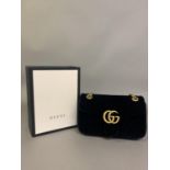 Gucci: a black velvet front flap Marmont cross body bag in black quilted velvet, gold metal and