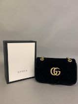 Gucci: a black velvet front flap Marmont cross body bag in black quilted velvet, gold metal and