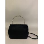 Gucci: a black satin evening bag, the silver metal top handle in bamboo form, silver metal frame,
