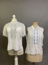 Two fine white cotton lawn vintage blouses, the first sleeveless, the collar and bodice front panels