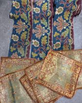 Cushion panels and upholstery: A Victorian carpet border in shades of indigo, crimson, and ochre,