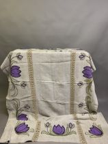 Arts and Crafts turnback silk embroidered and appliqué bedcover worked on a natural linen ground,