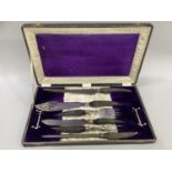 A six piece Sheffield cutlery co. horn handled and silver mounted carving set, fitted in leather